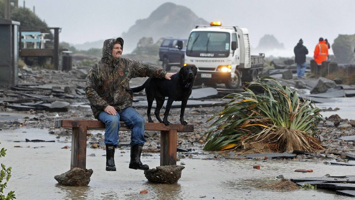 Noel Henderson and his dog Beanie makes the most of the washed up seat. Picture: PHIL REID