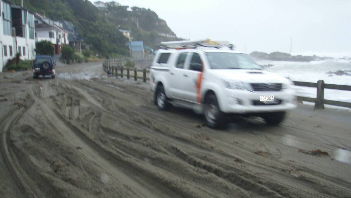Sand washes ashore on a road in Wellington. Picture: NIKKI MACDONALD