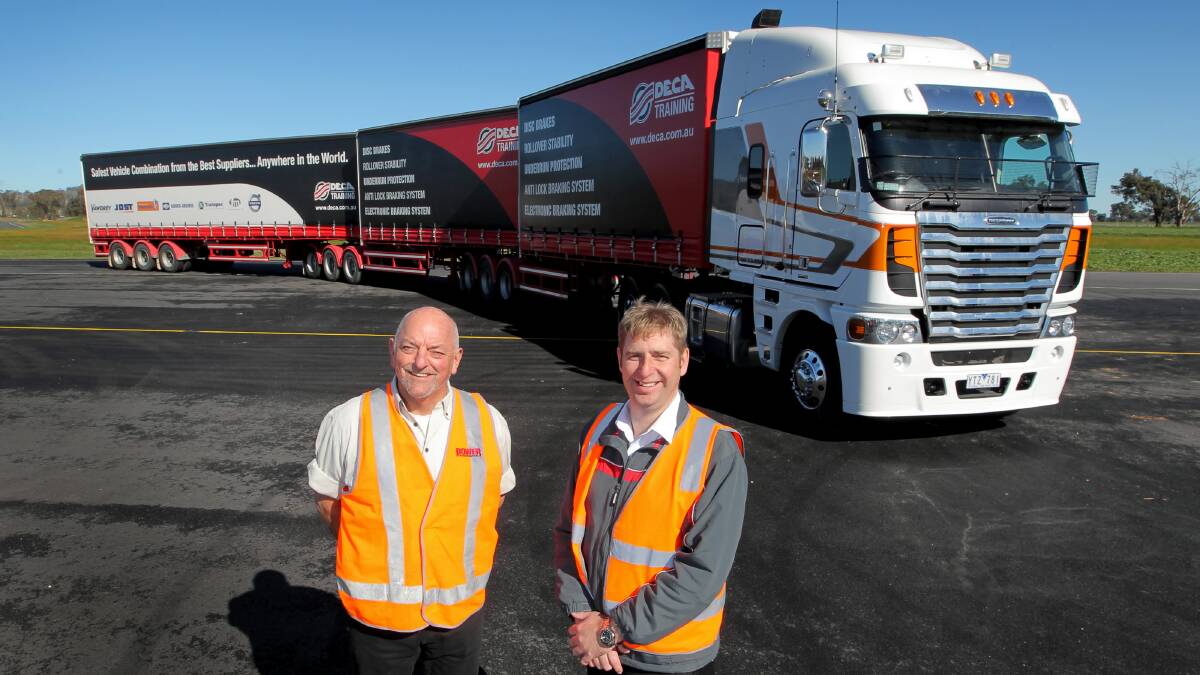 Motoring Matters representative Chris Mullettand Freightliner senior manager Rob West with the new Argosy model and the B-triple trailer configuration. Pictures: DAVID THORPE