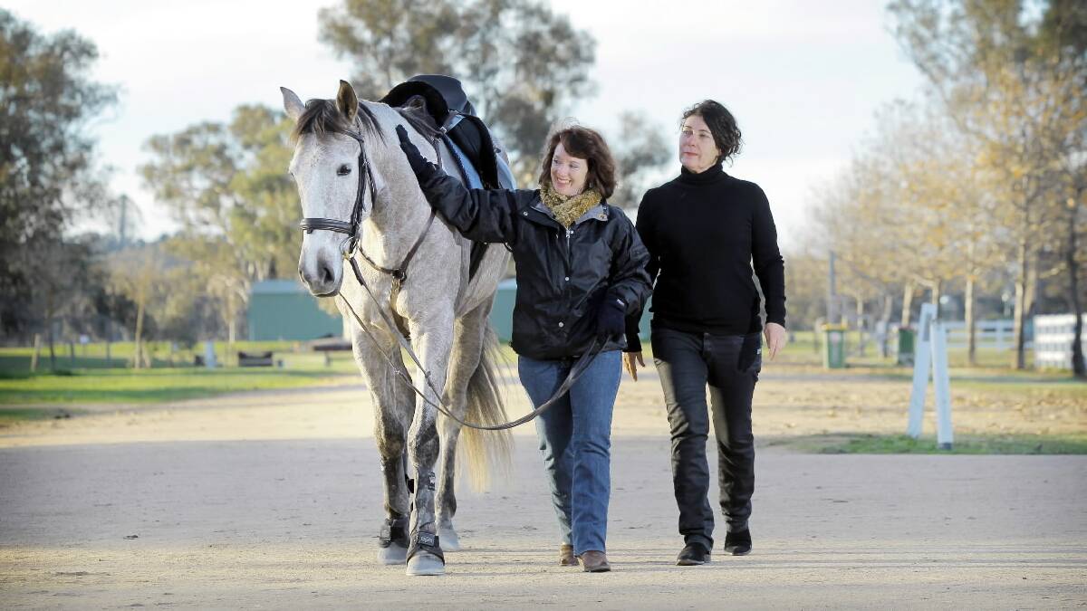 Guest speaker Jennifer Watterson, of Bundaberg, and Albury's Annette Baker met for the first time at othe equestrian centre that brought Annette's daughter so much joy. They're pictured with horse Zalador. Pictures: TARA GOONAN