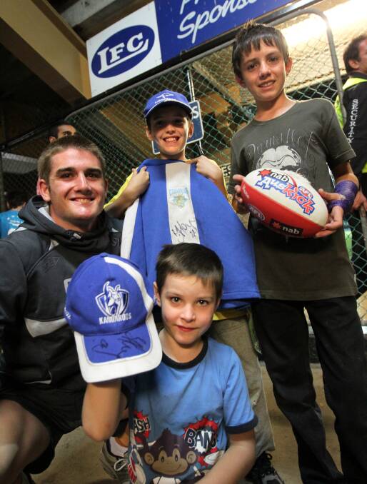  Footballer Anthony Miles pauses for a photograph with fans Billy-Lee Berthun, 9, Ryan Bertun, 6, and Cameron Berthun, 13, during an NAB Cup match at Lavington in 2011.