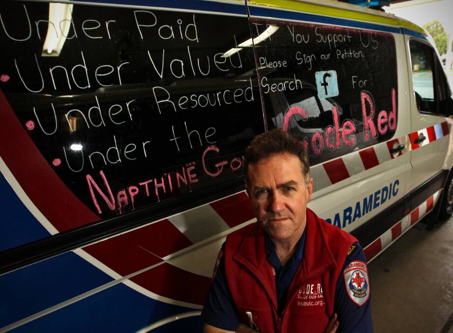 Wodonga Ambulance manager Mike Fuery stands with a “war-chalked” ambulance. Picture: BEN EYLES