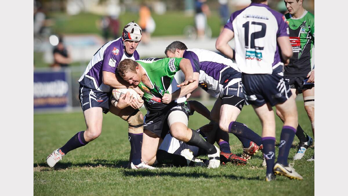 Thunder's Josh Cale looks set to lose his shirt after being tackled by several South City players. Picture: BEN EYLES