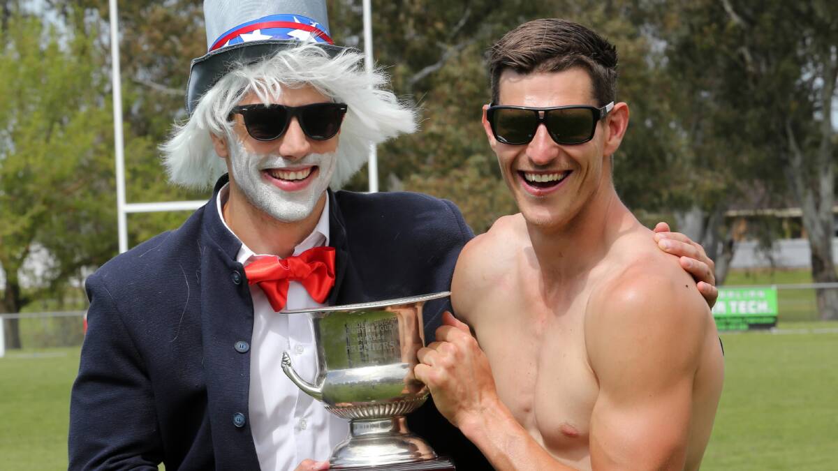 Brothers Mitch and Chris Seaton show off the premiership cup during the Thunder’s Mad Monday celebrations. Pictures: PETE MERKESTEYN