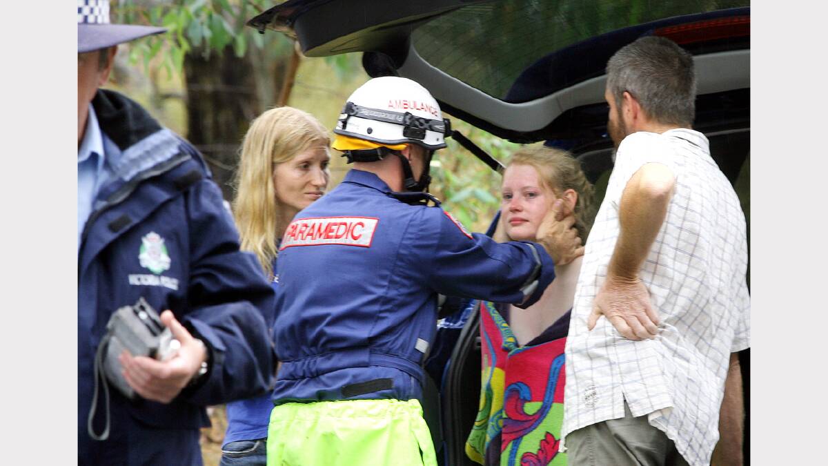 .Young female driver is checked by paramedic at a single vehicle crash on the Kiewa Valley Highway at Kergunyah. Picture: RAY HUNT