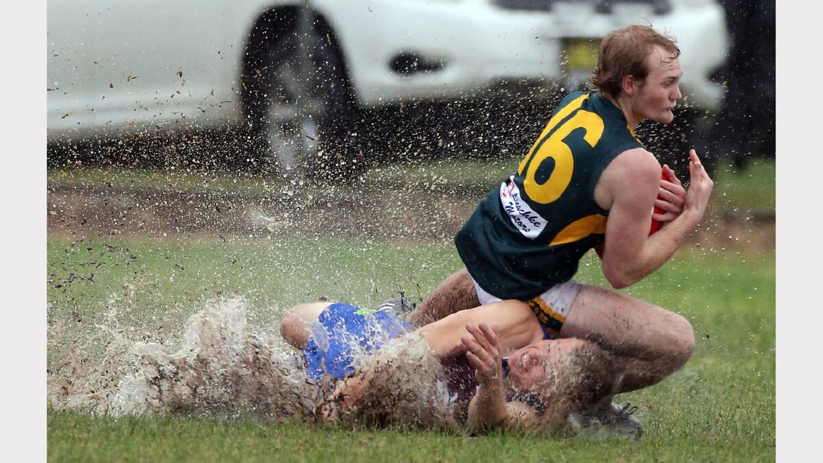  Culcairn's Brendan Way and Holbrook's Stewart Williams fight for the mark in a wet mess. Picture: PETER MERKESTEYN