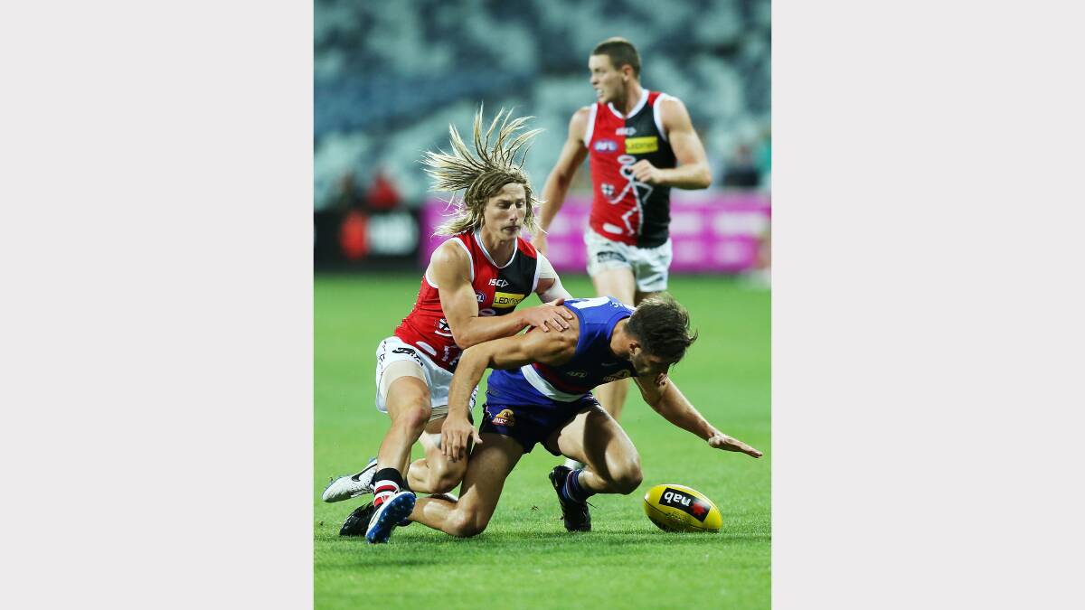 Eli Templeton of the Saints tackles Koby Stevens of the Bulldogs during the round two AFL NAB Challenge Cup match between the Western Bulldogs and the St Kilda. Picture: GETTY IMAGES