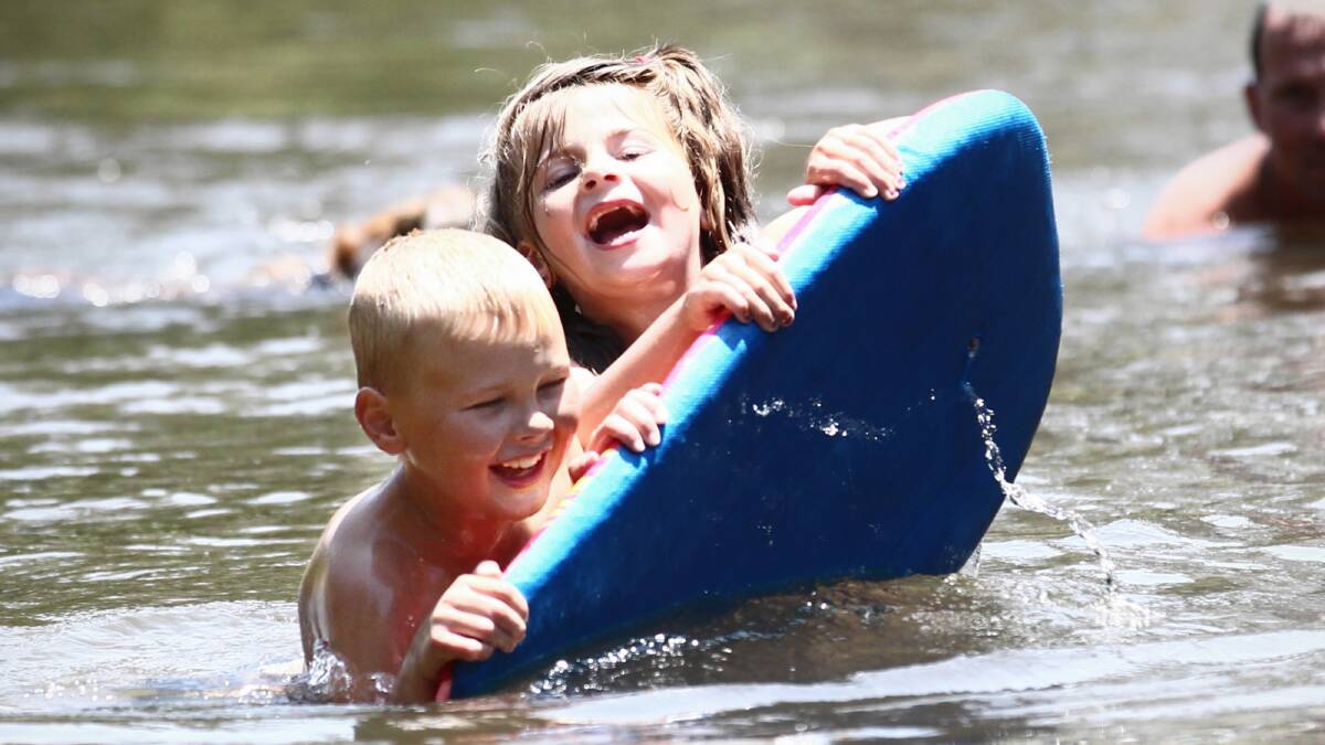  Brady Vauhkonen, 8, and Alicia Turner, 5, play in the Kiewa River near Riverside Estate. Pictures: BEN EYLES