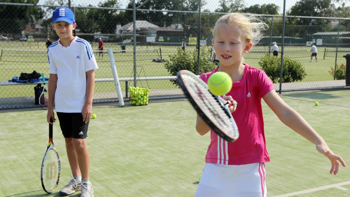  James Plested, 9 watches his sister, Sienna Plested, 7 return a ball during a practice match. Picture: PETER MERKESTEYN