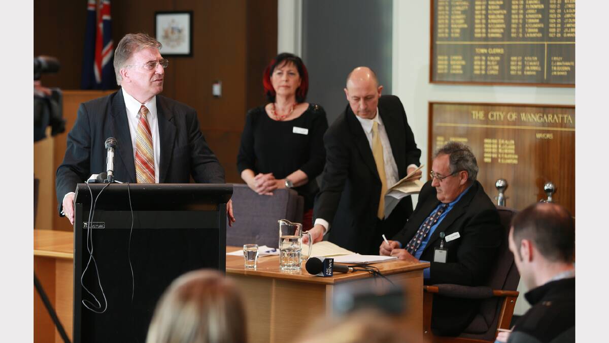 Wangaratta chief executive Kelvin Spiller speaking at a press conference following the sacking of the entire council. Julian Fidge hands out copies of a letter he has drafted during the press conference.