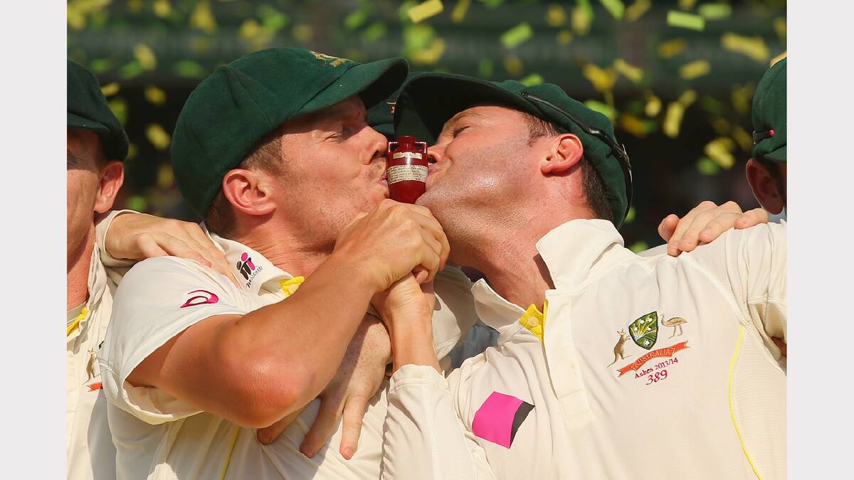 Peter Siddle and Michael Clarke kiss the urn, celebrating victory in the test and the series during the presentation ceremony. 