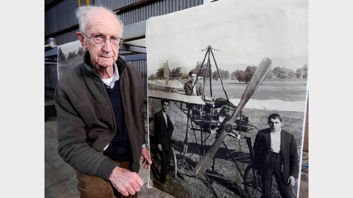  Geoff Robbins with a photo of the original plane. Featured is his great uncle, Azor Robbins, seated in the plane is Vivian Porter and on the right is Alex Porter. Picture: PETER MERKESTEYN
