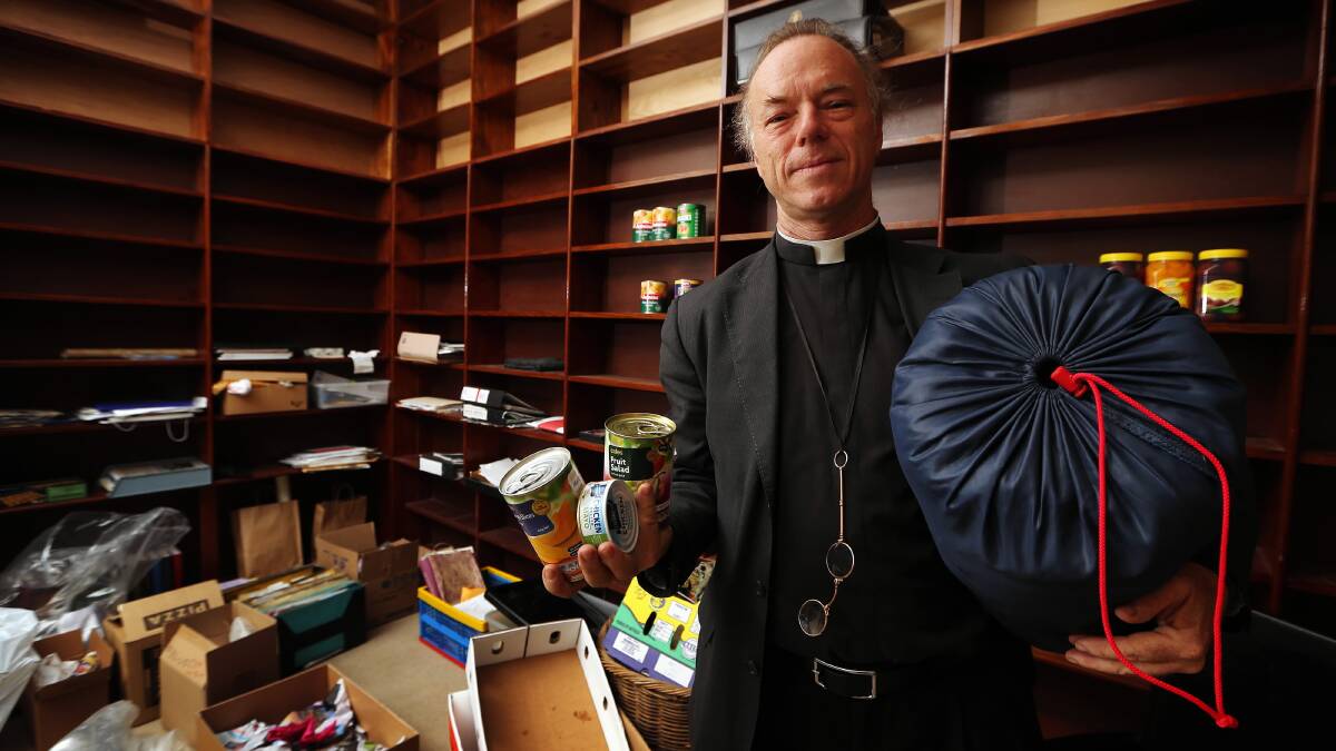 Father Peter MacLeod-Miller stands in an emptied out store area after helping out homeless people with suplies over the Christmas period. Picture: JOHN RUSSELL