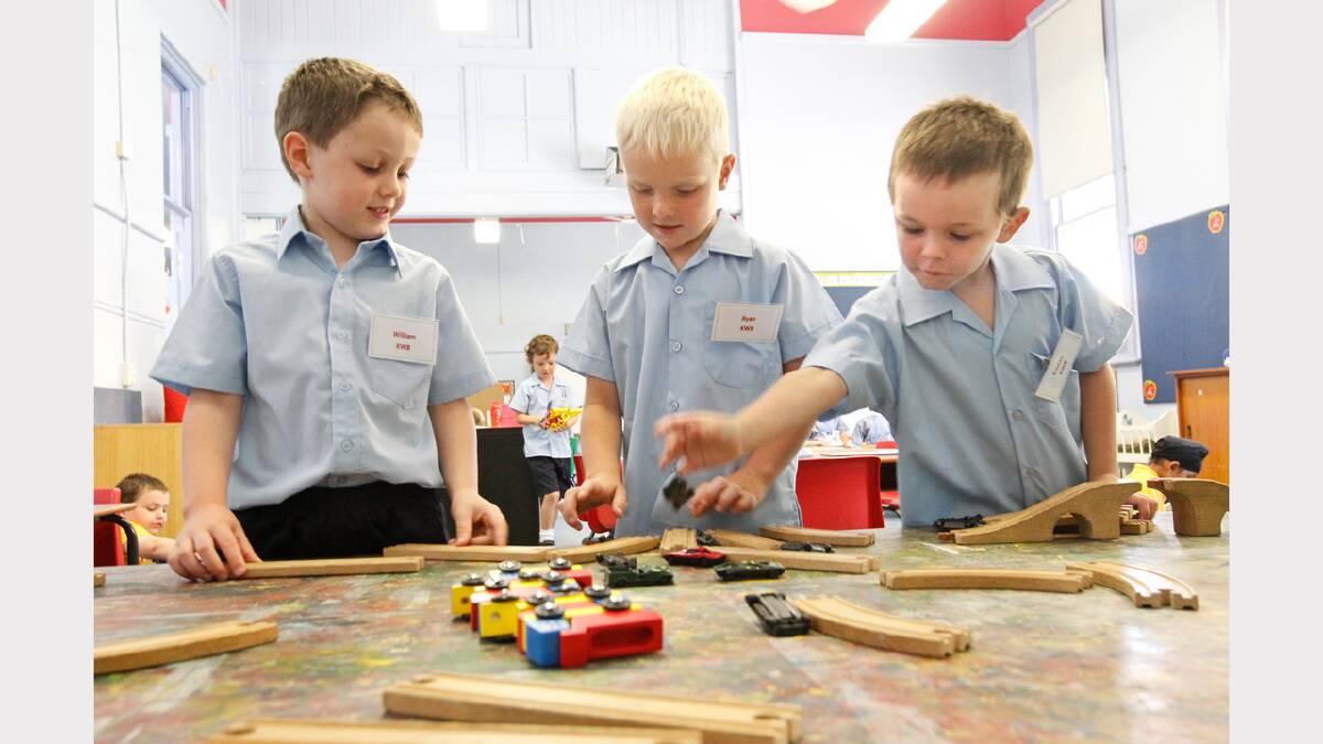 William Burgess, Ryan Tinworth and Tristan Abbott build train tracks during their first day at kinder at Albury Primary School. Picture: BEN EYLES