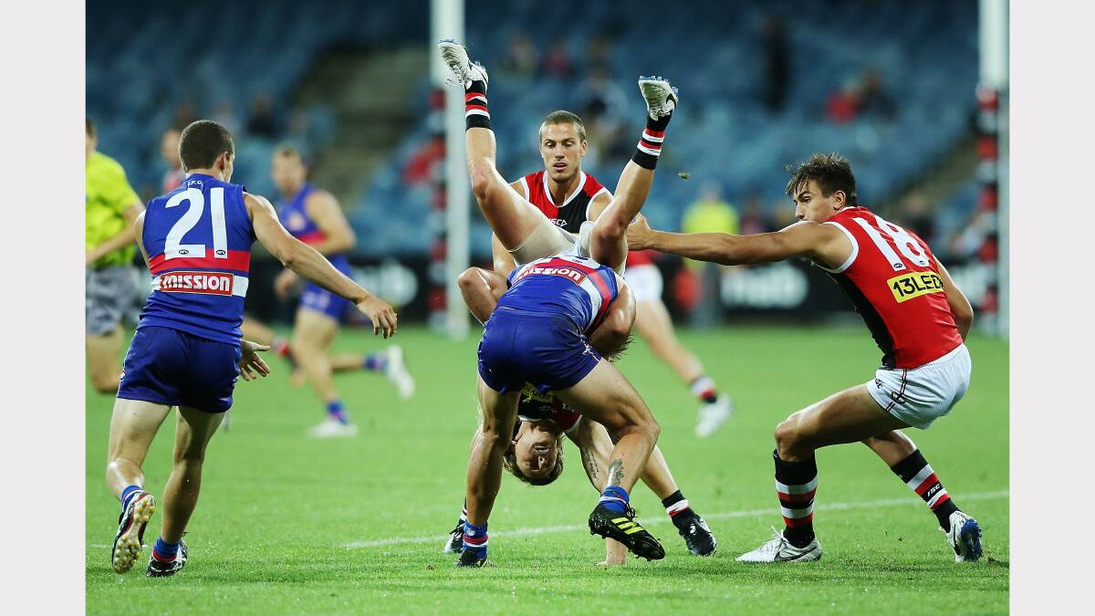  Eli Templeton of the Saints tackles and tumbles over Koby Stevens of the Bulldogs during the round two AFL NAB Challenge Cup match between the Western Bulldogs and the St Kilda. Picture: GETTY IMAGES
