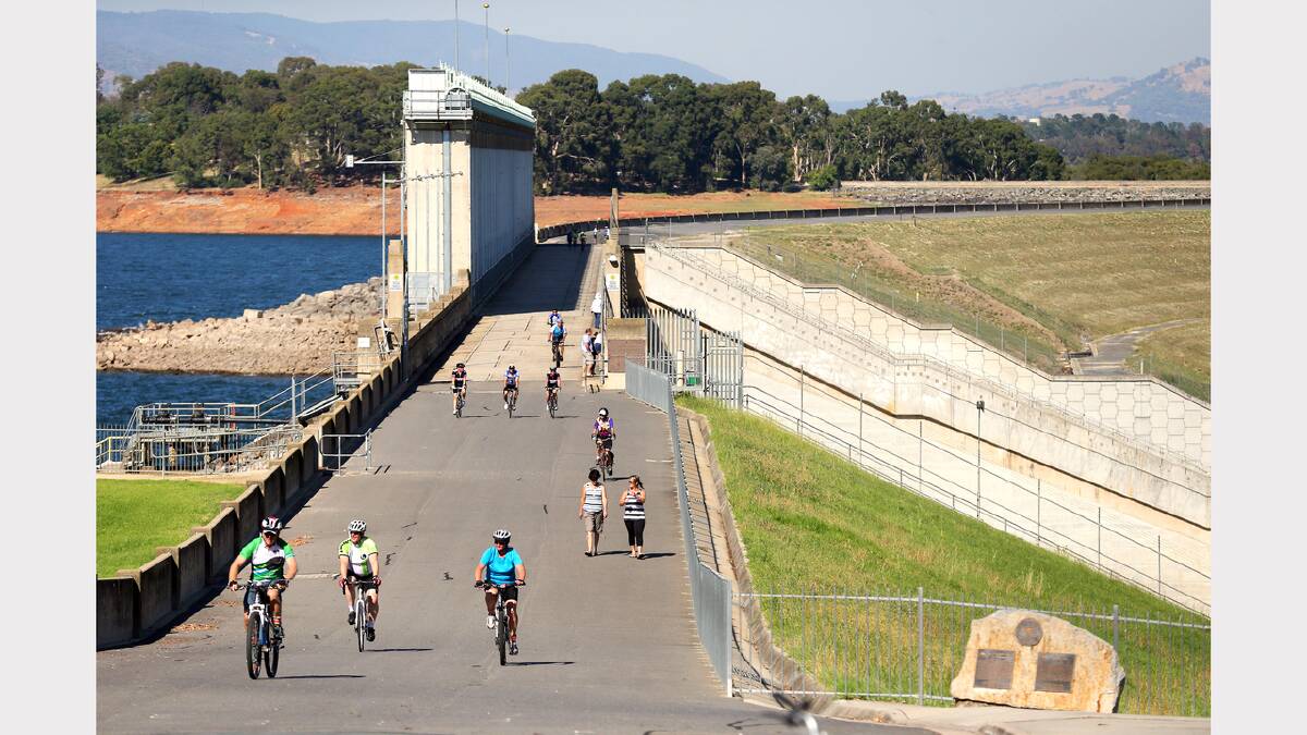 Riders in the Lake Hume Challenge cross the Weir Wall for the first time in years as part of a number of rides starting in Albury.