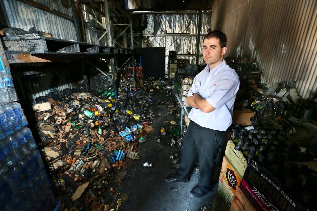 East Albury IGA manager JP Mathews standing in the storeroom of the shop after it was ravaged by fire. Pictures: MATTHEW SMITHWICK