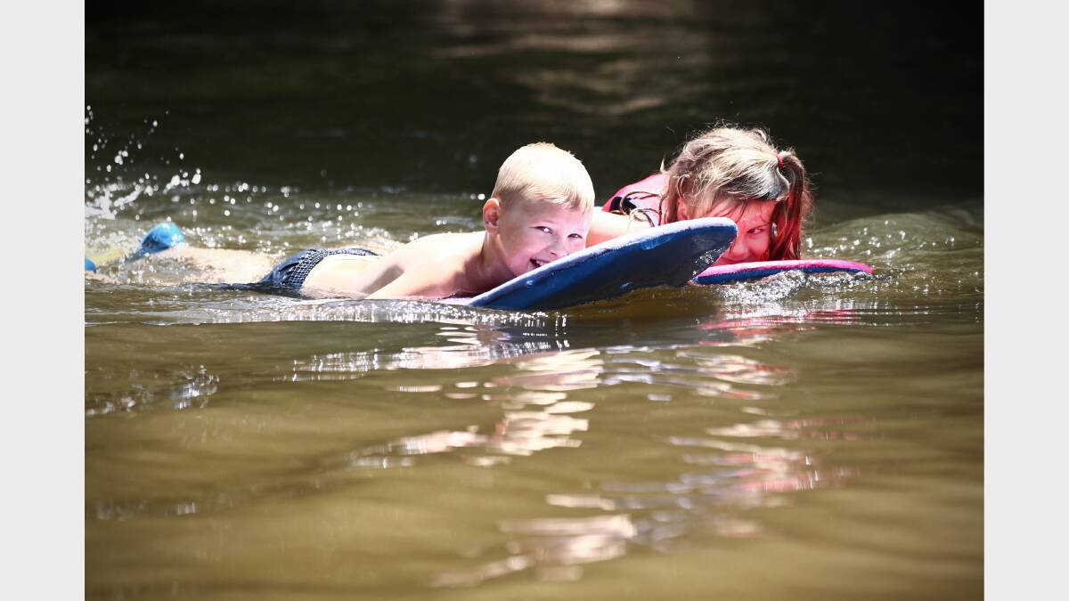  Brady Vauhkonen, 8, and Alicia Turner, 5, play in the Kiewa River. 