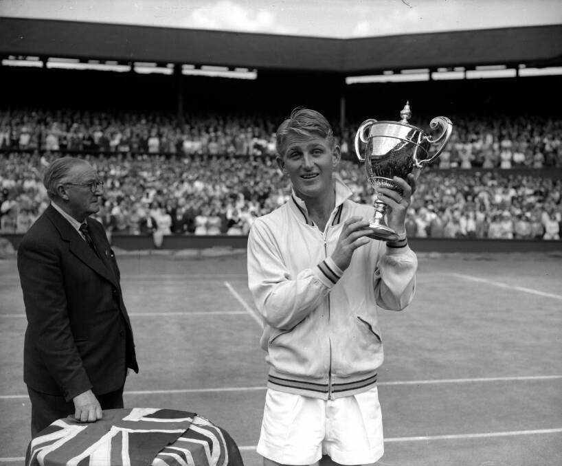Australian tennis player Lew Hoad on centre court with the Wimbledon Men's Singles Trophy after beating fellow Australian Ken Rosewall in the 1956 final.  