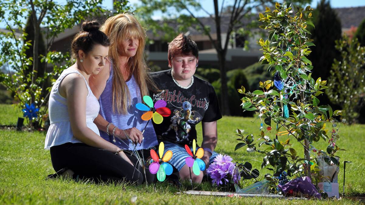 Tayla Crane, 19, Marcelle Rudd and her daughter Sarah Aylward, 17,  visit the memorial of Marcelle's son Dylan Aylward who died in March after crashing his motorbike. Picture: MATTHEW SMITHWICK