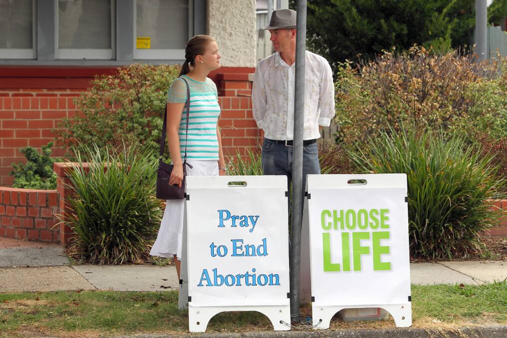 Two protesters to abortion stand outside the clinic in Englehardt Street. Picture: MATTHEW SMITHWICK