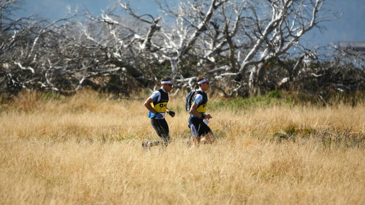 Two  athletes compete in an adventure race in the high plains near Falls Creek. Picture: SUPPLIED