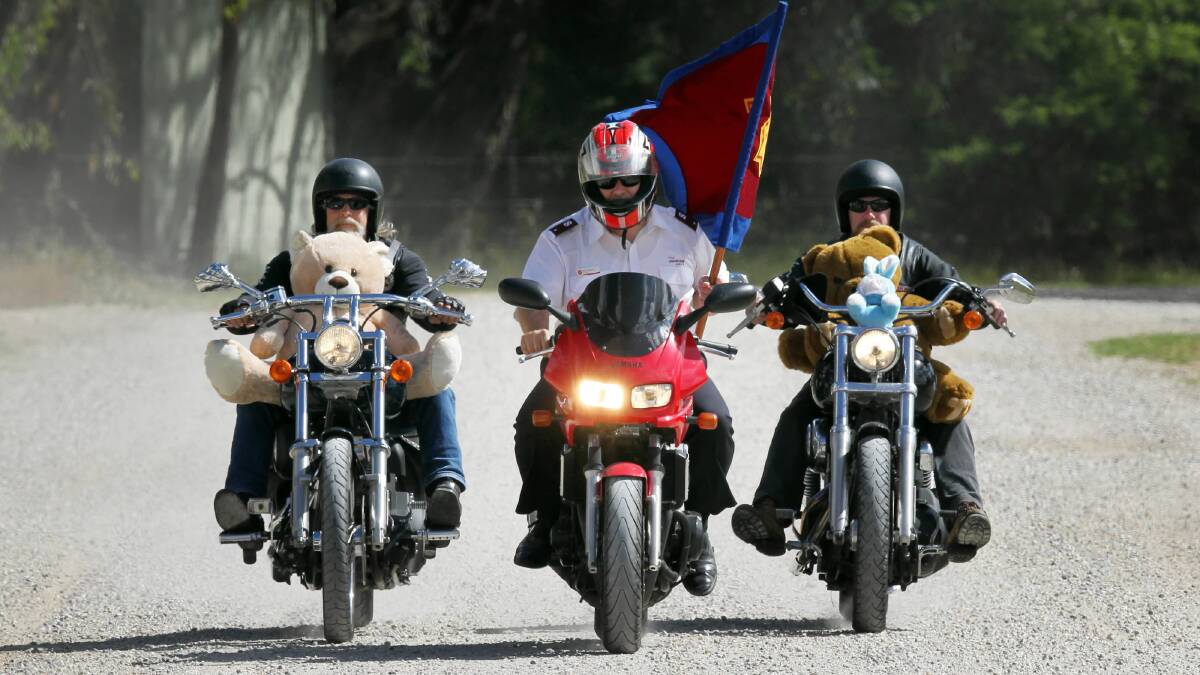 Party Unlimited riders Ken Lindsay and Nick Tol, flanking Salvation Army Lieutenant Rod Parsons, gear up for the Christmas toy run tomorrow. The Albury event has been running for 26 years. Picture: MARK JESSER