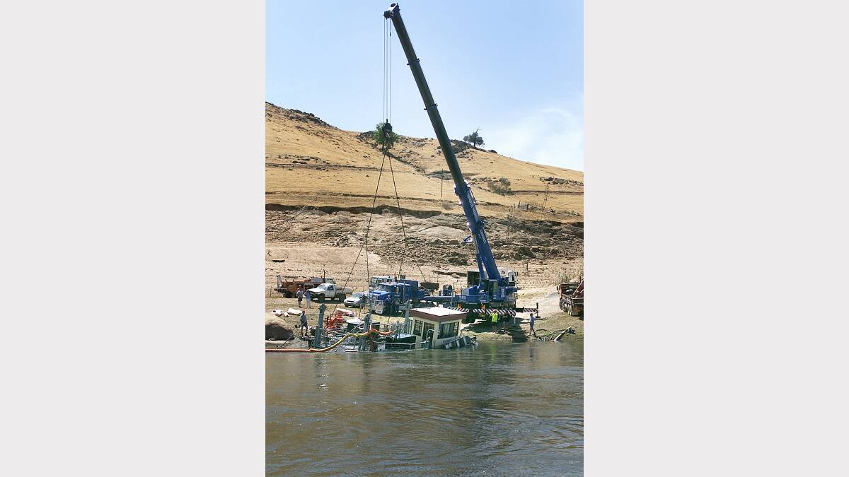 With the assistance of this giant crane and 2 water pumps the Wymah Ferry was raised from the water and placed on the bank on February 7, 2003.
