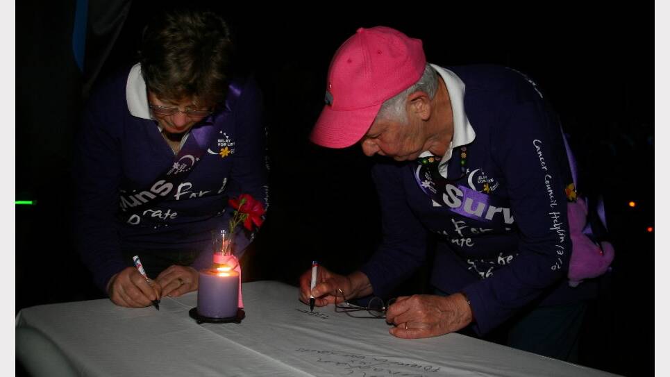 2011 - Wodonga cancer survivors Denise Arnel and June Joynson sign the memorial cloth. 