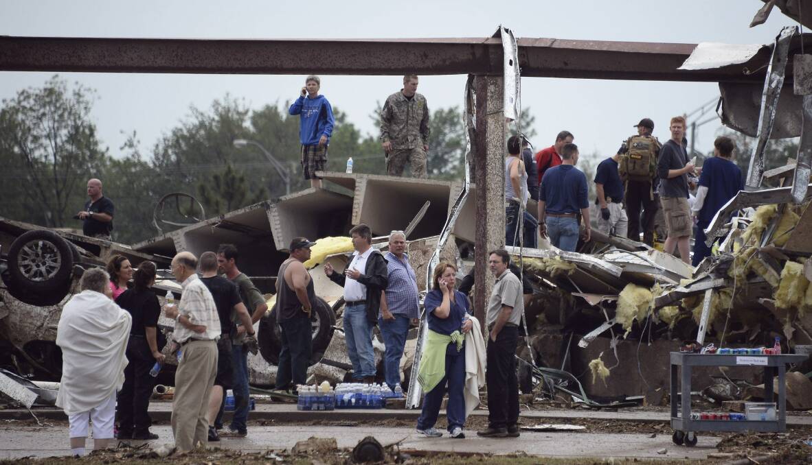 Residents and rescuers look over the damage after a tornado struck Moore, Oklahoma, May 20, 2013. Photo: REUTERS/Gene Blevins