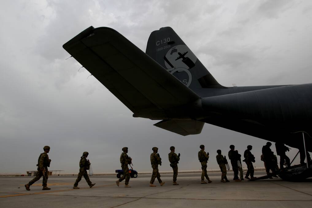 Australian troops board a C-130 aircraft departing Al Minhad Air Base for deployment to Afghanistan, on 21 April 2013. Photo: Alex Ellinghausen