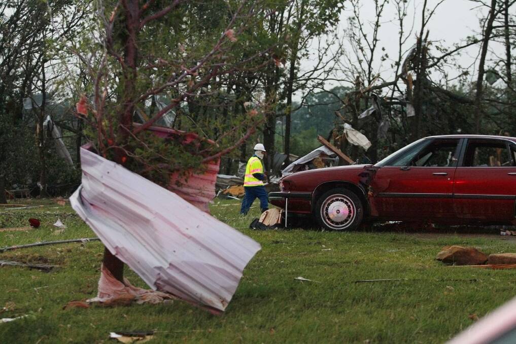An official walks next to storm debris at a mobile home park which was destroyed by a tornado west of Shawnee, Oklahoma. Photo: REUTERS