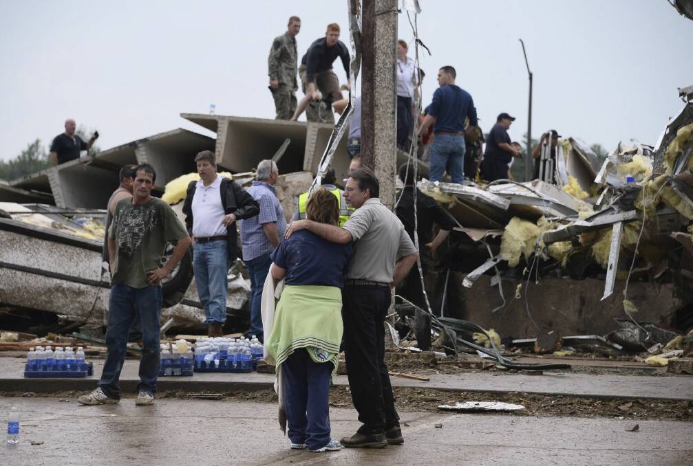 Residents and rescuers look over the damage after a tornado struck Moore, Oklahoma, May 20, 2013. Photo: REUTERS/Gene Blevins