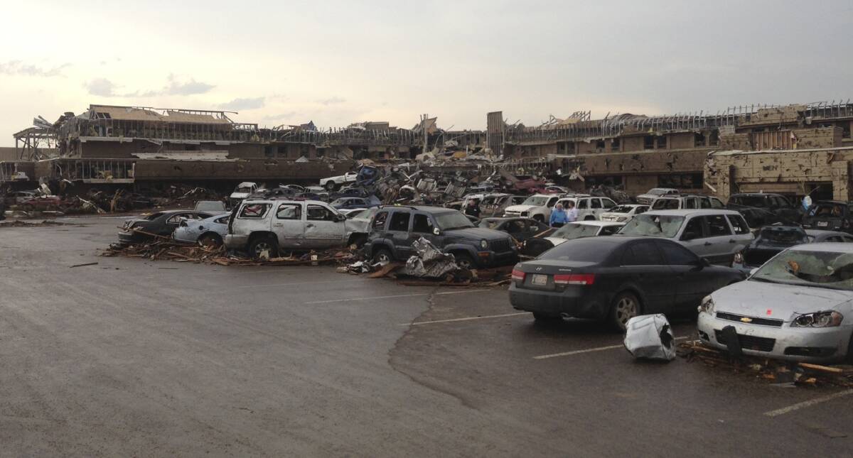 A shopping center and parking lot are filled with debris after a huge tornado struck in Moore, Oklahoma. Photo: REUTERS