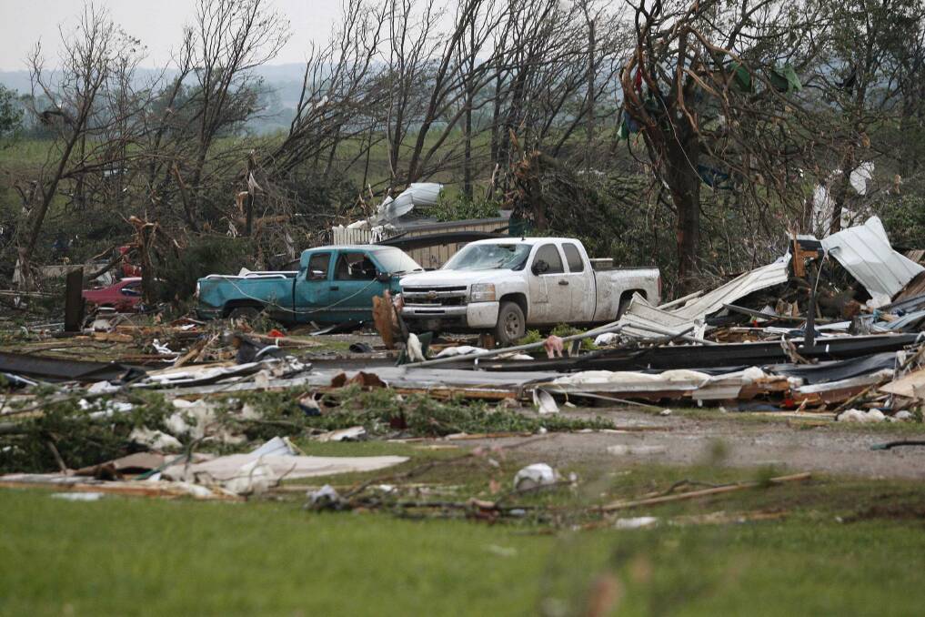 Vehicles are seen amongst storm debris, which is what is left of a mobile home park destroyed by a tornado, west of Shawnee, Oklahoma. Photo: REUTERS