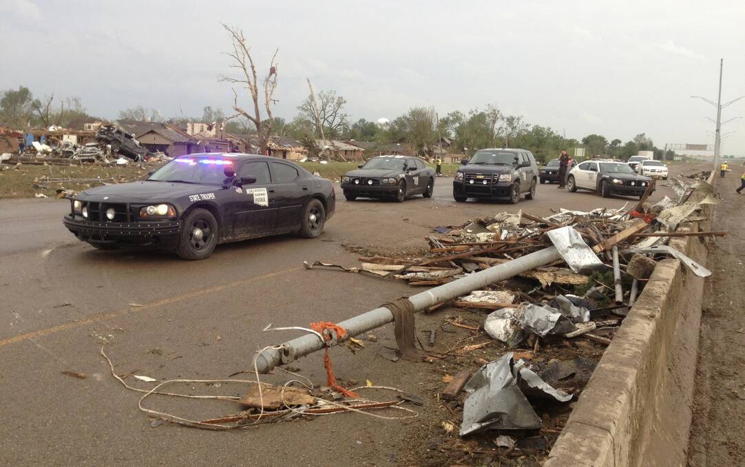 Law enforcement officials arrive on the scene after a huge tornado struck Moore, Oklahoma, near Oklahoma City, May 20, 2013. Photo: REUTERS/Richard Rowe