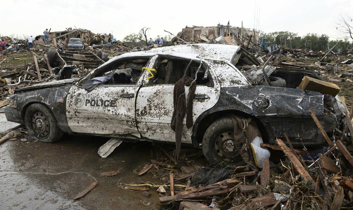A damaged police car is seen after a tornado struck Moore, Oklahoma, May 20, 2013. Photo: REUTERS/Gene Blevins