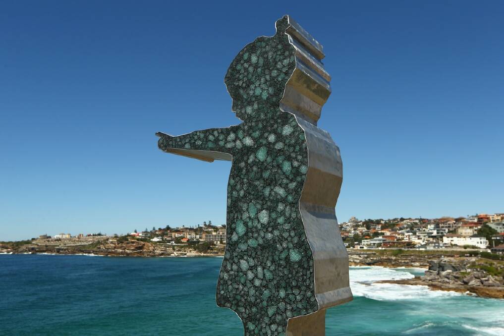 : 'Girl Pointing' by artist Matt Calvert is displayed during the 2013 Sculptures by the Sea exhibition at Bondi on October 24. (Photo by Cameron Spencer/Getty Images)