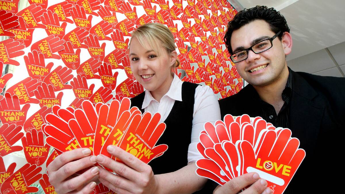 Kim-Sheree Skepper and Lachlan Pereira, of McDonald’s, lend a helping hand to the Ross Bowling Appeal. Picture: PETER MERKESTEYN