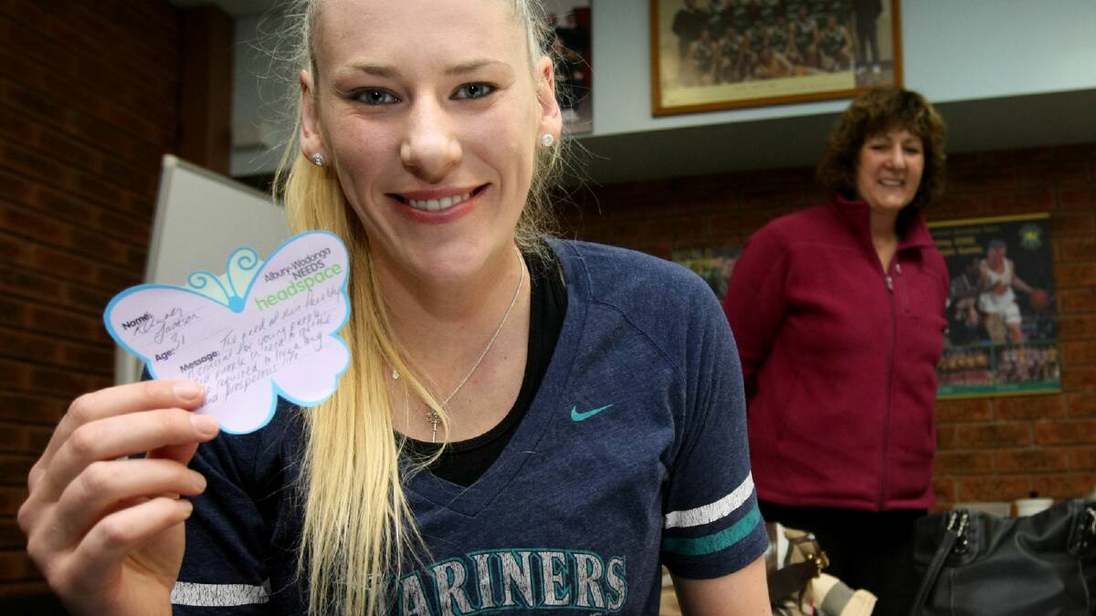 Lauren Jackson fills out a headspace butterfly as mum Maree looks on. Picture: JOHN RUSSELL