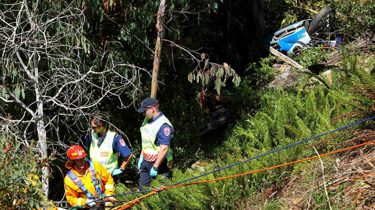 The wreckage of the dead motorcyclist’s high-performance Suzuki GSXR sports bike can be seen behind emergency service workers on the cliff face near Falls Creek and, below, the point where the rider left the road. Pictures: MATTHEW SMITHWICK