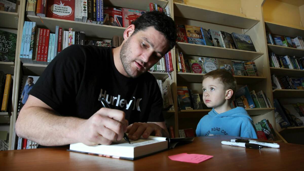 Brendan Fevola signing a copy of his autobiography for Bailey Robb, 4, of Wodonga, who was totally in awe of his hero. Picture: TARA ASHWORTH